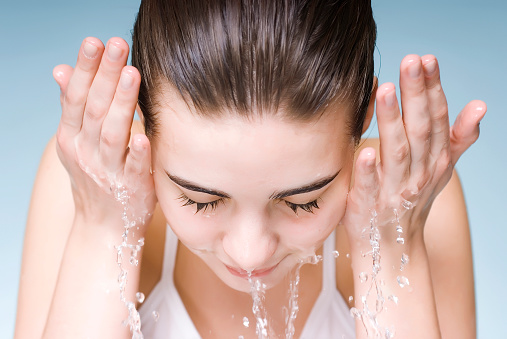 Fresh and lovely woman washing her face